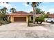 Charming single-story home featuring a terra cotta tile roof, attached garage, and meticulously landscaped front yard at 5057 Maui Cir # 15, Orlando, FL 32808