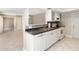 Kitchen features white cabinets, appliances, and decorative backsplash with tile floors at 5057 Maui Cir # 15, Orlando, FL 32808