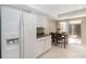 Bright kitchen features white cabinets, stainless steel refrigerator and dining area at 5057 Maui Cir # 15, Orlando, FL 32808