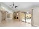 Bright living room with tile floors, fireplace, and sliding glass doors view of the pool at 5057 Maui Cir # 15, Orlando, FL 32808
