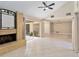 Spacious living room with tile floors, brick fireplace, and sliding glass doors to the patio at 5057 Maui Cir # 15, Orlando, FL 32808