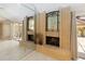 Living area featuring a brick fireplace, mirror wall, and access to outdoor patio at 5057 Maui Cir # 15, Orlando, FL 32808