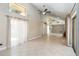 Living room with high ceilings, mirrored wall, fan and large windows for natural light at 5057 Maui Cir # 15, Orlando, FL 32808