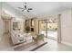Comfortable living room with a fireplace, ceiling fan and access to the pool area at 5057 Maui Cir # 15, Orlando, FL 32808