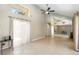 Open-concept living room features a large window and mirrored accent wall at 5057 Maui Cir # 15, Orlando, FL 32808