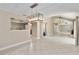 Open living room with tile floors, brick fireplace, and view to the dining room at 5057 Maui Cir # 15, Orlando, FL 32808