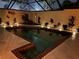 Sparkling pool surrounded by tropical plants and accent lighting for evening enjoyment at 5057 Maui Cir # 15, Orlando, FL 32808