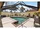Inviting screened-in pool area, complete with patio furniture and lush tropical landscaping, perfect for relaxation at 5057 Maui Cir # 15, Orlando, FL 32808