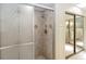 Enclosed shower with neutral toned tilework and decorative glass door at 5057 Maui Cir # 15, Orlando, FL 32808