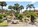 Lush tropical landscaping surrounds a serene water feature with a stone bench at 5057 Maui Cir # 15, Orlando, FL 32808