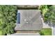Aerial view of a home's roof with solar panels, skylights, surrounded by lush landscaping at 519 Cadiz Dr, Davenport, FL 33837