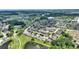 Beautiful aerial shot of the community and golf course surrounded by a tranquil lake at 519 Cadiz Dr, Davenport, FL 33837