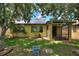 Backyard view of home featuring solar panels, a screened in porch, and mature trees for shade and privacy at 519 Cadiz Dr, Davenport, FL 33837