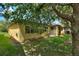 The backyard has a well-maintained lawn and mature trees that offer ample shade and privacy at 519 Cadiz Dr, Davenport, FL 33837