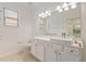 Bright bathroom with a large vanity, a wide mirror, and a tiled floor at 519 Cadiz Dr, Davenport, FL 33837