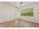 Large, bright bedroom with wood-look tile floors and a view of the lush landscaping at 519 Cadiz Dr, Davenport, FL 33837