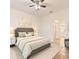 A well-lit bedroom featuring a neutral color scheme, with a view to the en-suite bathroom at 519 Cadiz Dr, Davenport, FL 33837