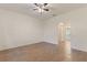 Open bedroom space with wood-look tile flooring and a doorway to a bathroom at 519 Cadiz Dr, Davenport, FL 33837