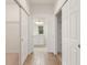 Hallway featuring wood-look floors and an ensuite bathroom at 519 Cadiz Dr, Davenport, FL 33837