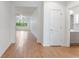 Inviting hallway with wood-look tile flooring, white walls, and views into the living and dining spaces at 519 Cadiz Dr, Davenport, FL 33837
