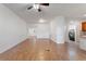 Open living area with hardwood floors, white walls, and a view of the laundry room and front door at 519 Cadiz Dr, Davenport, FL 33837