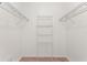 Spacious walk-in closet featuring white walls, carpet floors, and wire shelving on three walls at 519 Cadiz Dr, Davenport, FL 33837