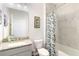 Bright bathroom features granite countertops, a tub with shower, and modern fixtures at 5627 Orange Orchard Dr, Winter Garden, FL 34787