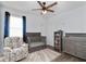 Cozy Bedroom features a crib, patterned rug, a comfortable chair, and a changing table at 5627 Orange Orchard Dr, Winter Garden, FL 34787