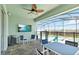 Relaxing covered patio with a ceiling fan, furniture, and a view of the pool and surrounding landscape at 5627 Orange Orchard Dr, Winter Garden, FL 34787
