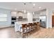 Modern kitchen featuring a large island with seating, stainless steel appliances, granite countertops, and ample storage space at 5627 Orange Orchard Dr, Winter Garden, FL 34787