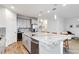Contemporary kitchen with a spacious island, stainless steel appliances, a wine cooler, and sleek white cabinetry at 5627 Orange Orchard Dr, Winter Garden, FL 34787