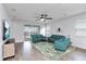 Bright living room featuring modern furnishings, hardwood floors, a ceiling fan, and sliding glass doors to the outdoor patio at 5627 Orange Orchard Dr, Winter Garden, FL 34787