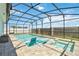 Inviting backyard pool and spa featuring in-pool loungers and a screened enclosure for year-round enjoyment at 5627 Orange Orchard Dr, Winter Garden, FL 34787