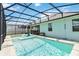 Backyard pool with comfortable in-pool loungers under a screened enclosure, perfect for relaxation at 5627 Orange Orchard Dr, Winter Garden, FL 34787