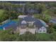 Aerial view of an estate home with a lake view, pool, sport court, and lush landscaping at 5801 Marleon Drive Marleon Drive, Windermere, FL 34786