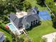 Aerial view of a luxury house with a pool, sport court, lush lawns and mature landscaping at 5801 Marleon Drive Marleon Drive, Windermere, FL 34786