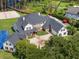 Stunning aerial view of a large luxury home with a pool, sport court, and beautiful landscaping at 5801 Marleon Drive Marleon Drive, Windermere, FL 34786