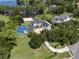 Aerial view of a sprawling estate with a basketball court, pool, and lush landscaping by the lake at 5801 Marleon Drive Marleon Drive, Windermere, FL 34786