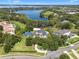 Overhead view of a lakeside luxury home with a pool, sport court, and beautifully landscaped grounds at 5801 Marleon Drive Marleon Drive, Windermere, FL 34786