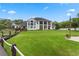 Large, expansive backyard features a beautiful lawn, rear balconies, and access to the pool and other outdoor areas at 5801 Marleon Drive Marleon Drive, Windermere, FL 34786
