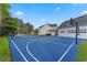 Full-sized, blue multi-purpose court with a tennis net is conveniently located next to the home's garages at 5801 Marleon Drive Marleon Drive, Windermere, FL 34786
