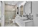 Modern bathroom featuring double sinks, mosaic tile accents, and a glass-enclosed shower at 5801 Marleon Drive Marleon Drive, Windermere, FL 34786