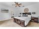 Bedroom with wood furnishings, carpet, and a ceiling fan. Doorway leads to bathroom at 5801 Marleon Drive Marleon Drive, Windermere, FL 34786
