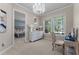 Bright bedroom area with a decorative chandelier and a connected room with a bed at 5801 Marleon Drive Marleon Drive, Windermere, FL 34786