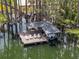 Scenic boat dock with chairs for relaxing near a lake, and a boat lift in place at 5801 Marleon Drive Marleon Drive, Windermere, FL 34786
