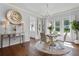 Bright dining room featuring modern chairs, chandelier, and hardwood floors at 5801 Marleon Drive Marleon Drive, Windermere, FL 34786