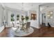 Elegant dining room with a glass table, chandelier and plenty of windows at 5801 Marleon Drive Marleon Drive, Windermere, FL 34786