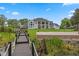 Expansive home featuring a wooden walkway leading to a volleyball court and well-manicured lawns at 5801 Marleon Drive Marleon Drive, Windermere, FL 34786