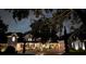 Nighttime view of an estate home with stone accents and a circular driveway with mature trees at 5801 Marleon Drive Marleon Drive, Windermere, FL 34786