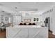A gourmet kitchen boasting white cabinets, large island, quartz countertops, and stainless steel appliances at 5801 Marleon Drive Marleon Drive, Windermere, FL 34786